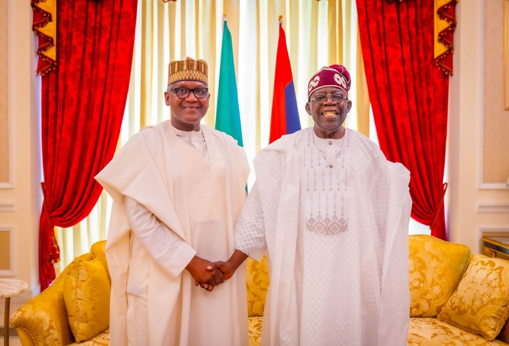 Chairman, Dangote Group, Aliko Dangote and President Bola Tinubu in a handshake at the Presidential Villa, Abuja.